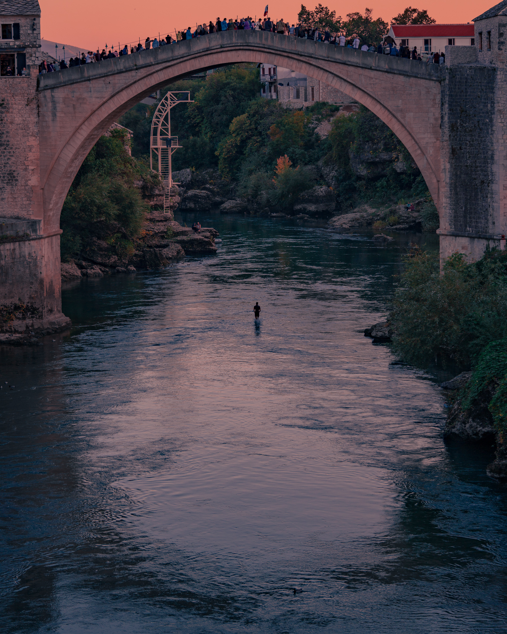 Mostar old bridge person jumping into water