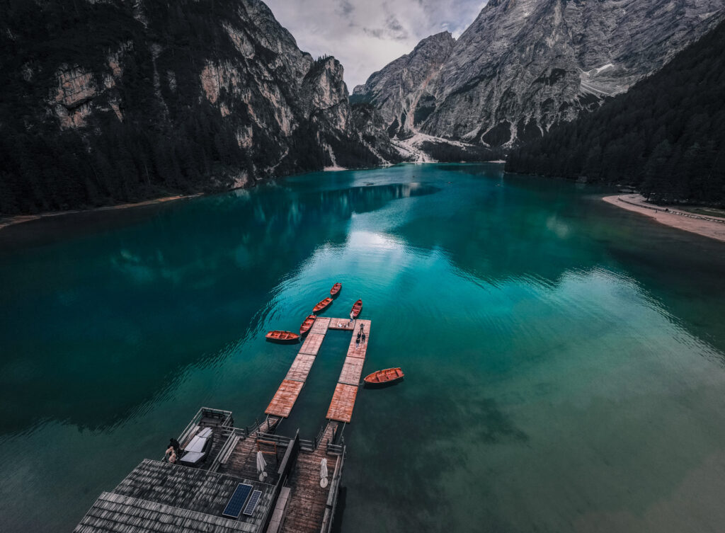 Lago-di-Braies-Dolomites-Lake-Family-road-trip-in-northern-italy-boats-lake-and-mountain-drone-shot