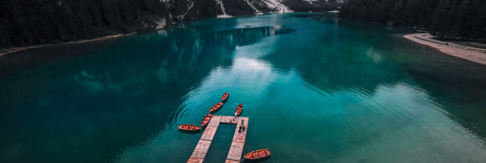 Lago-di-Braies-Dolomites-Lake-Family-road-trip-in-northern-italy-boats-lake-and-mountain-drone-shot