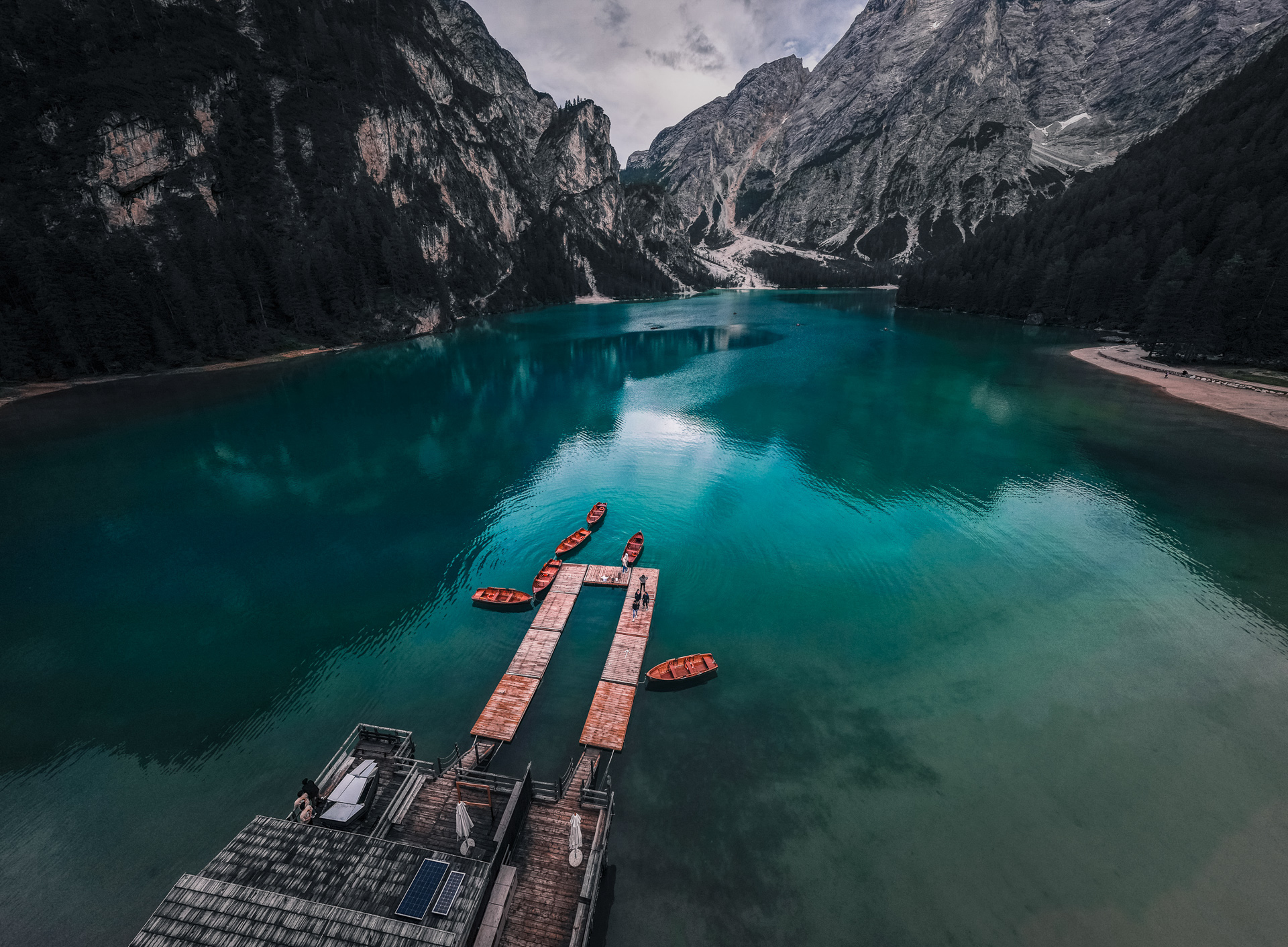 Lago-di-Braies-Dolomites-Lake-Family-road-trip-in-northern-italy-boats-lake-and-mountain-drone-shot