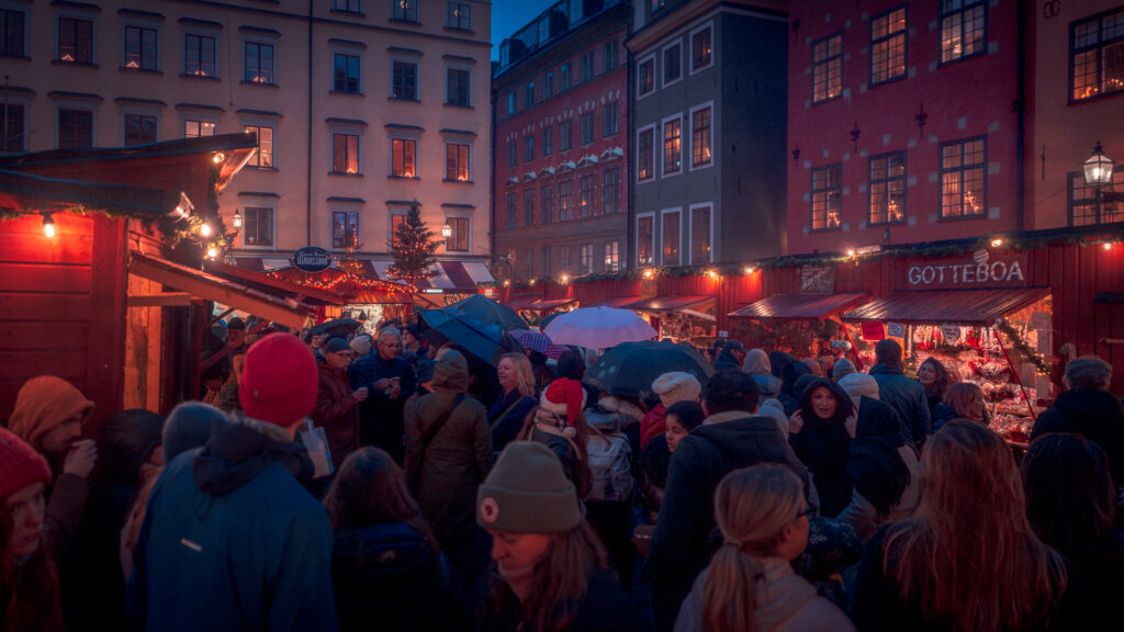 Christmas Market Stockholm Gamla Stan Stortorget - Crowd with Umbrellas in Rain