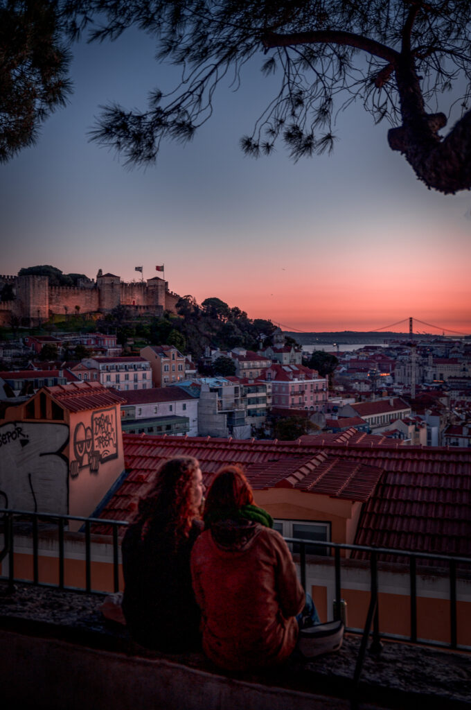 Miradouro da Graça - Best Sunset Viewpoint in Lisboa Portugal - Friends with view of São Jorge Castle