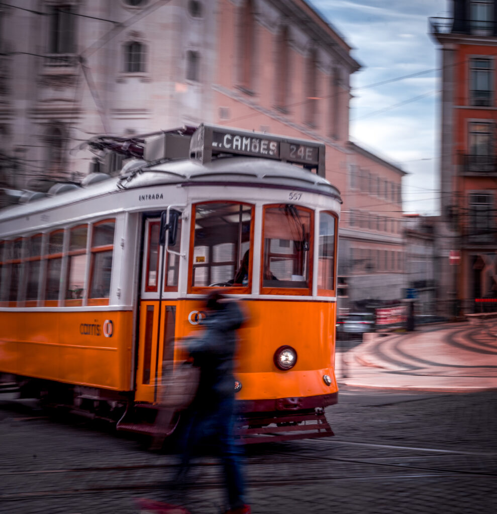 RIde Tram 28 - Best Transportation in Lisbon Portugal - Tram passing by person