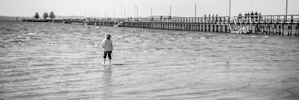 Kid at Rättwik Beach Looking out at Rättvik Long Pier (Långbryggan) - Summer Vacation Travel Photography