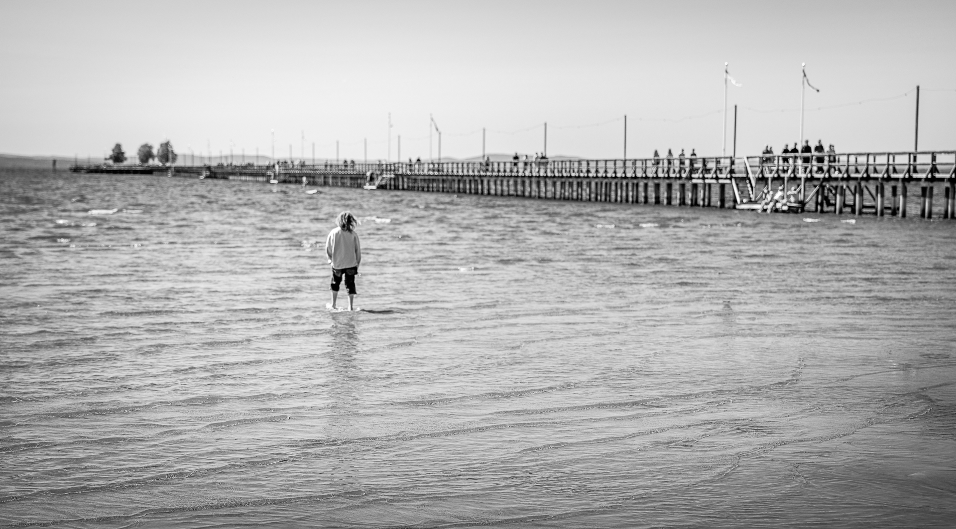 Kid at Rättwik Beach Looking out at Rättvik Long Pier (Långbryggan) - Summer Vacation Travel Photography